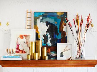 Mantel With Artwork, Arrows and Sconces